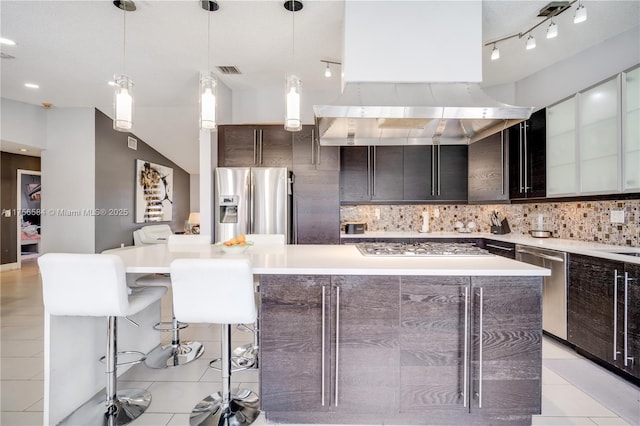 kitchen featuring a spacious island, visible vents, backsplash, light countertops, and appliances with stainless steel finishes