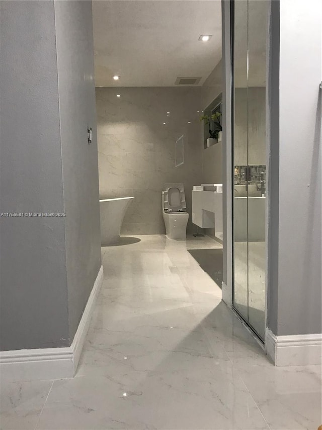 bathroom with visible vents, toilet, marble finish floor, a walk in shower, and recessed lighting