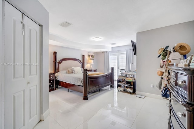 bedroom featuring light tile patterned floors, visible vents, and baseboards