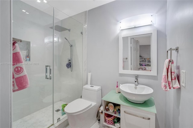 full bathroom featuring toilet, a stall shower, and vanity