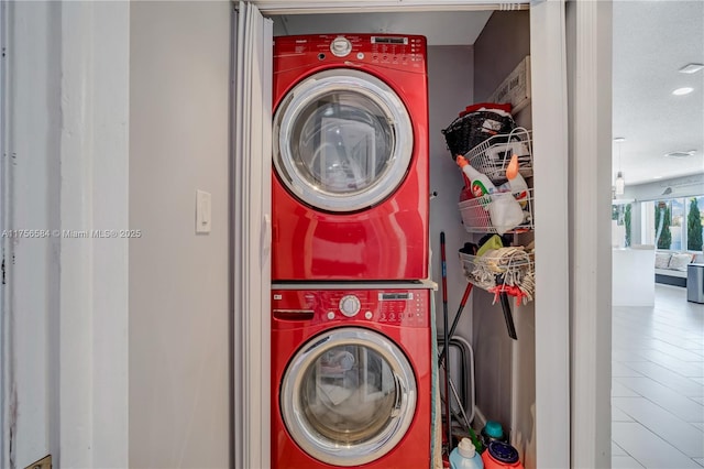 clothes washing area with laundry area and stacked washer / drying machine