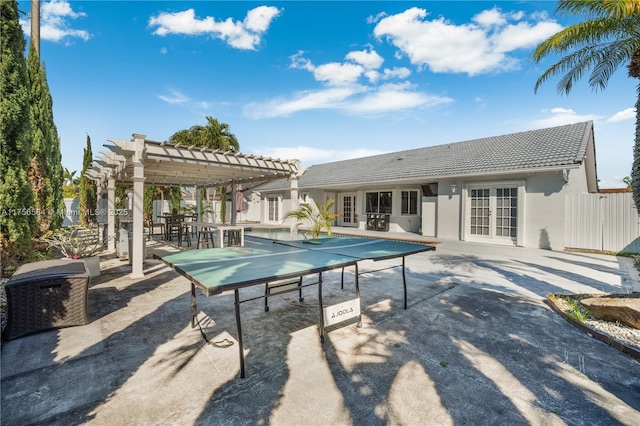 pool with french doors, a patio area, and a pergola