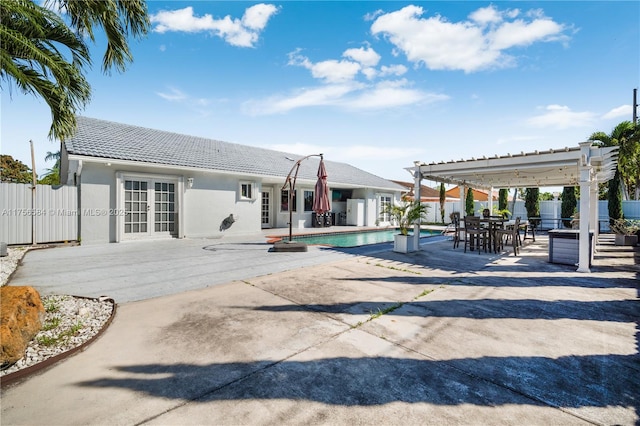 view of swimming pool featuring a patio, french doors, a pergola, and a fenced backyard