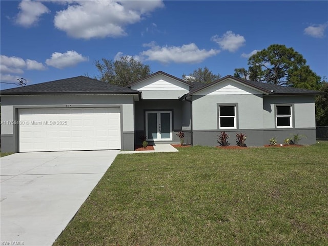 ranch-style home with a garage, driveway, french doors, a front lawn, and stucco siding