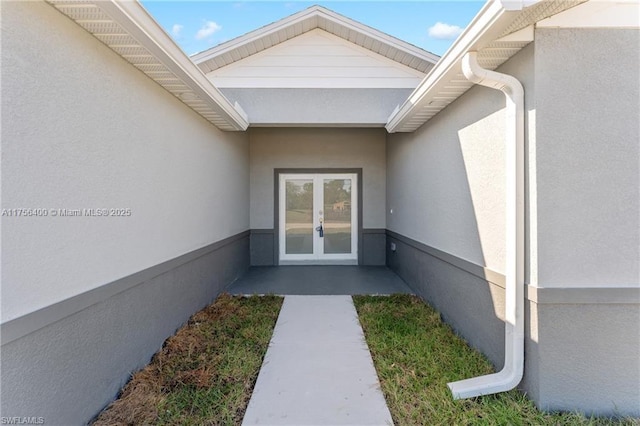 doorway to property with french doors and stucco siding