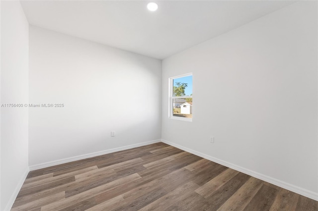 empty room with wood finished floors and baseboards