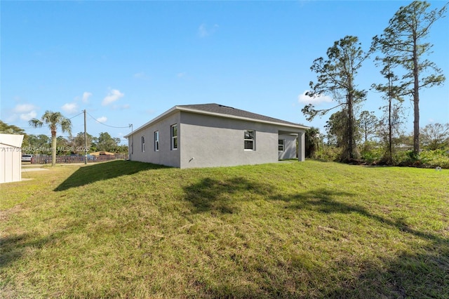 exterior space with a lawn and stucco siding