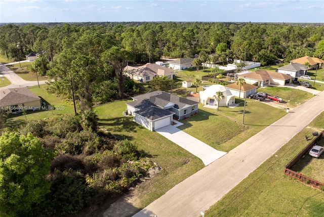 aerial view featuring a wooded view and a residential view