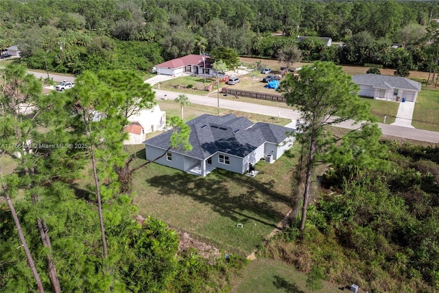 bird's eye view with a wooded view