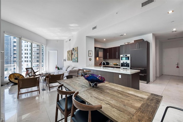 dining space with light tile patterned floors, visible vents, and recessed lighting