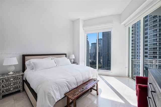 bedroom featuring access to exterior, a view of city, and light tile patterned floors