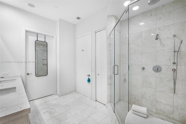 full bathroom with a stall shower, visible vents, and double vanity