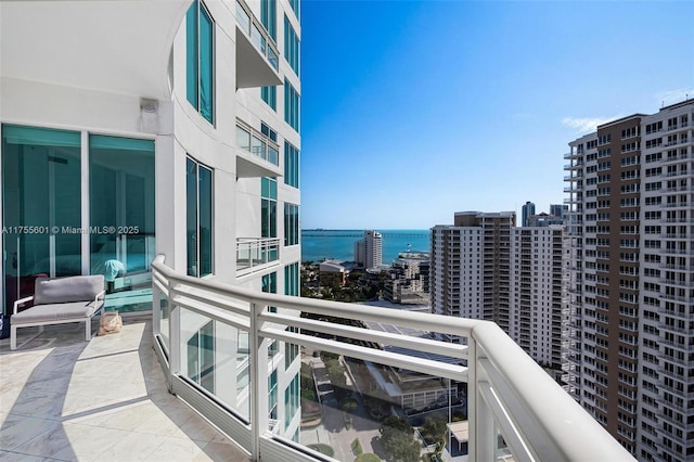 balcony featuring a view of city and a water view