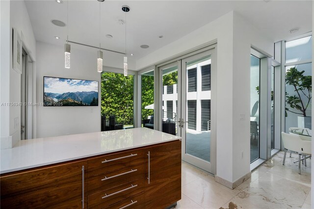 548 Fernwood Rd Unit 548, Key Biscayne, FL 33149 - kitchen featuring light countertops, french doors, marble finish floor, pendant lighting, and modern cabinets