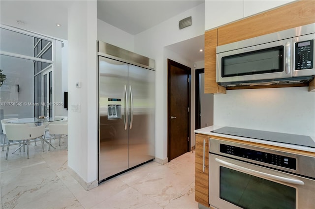 548 Fernwood Rd Unit 548, Key Biscayne, FL 33149 - kitchen featuring light countertops, stainless steel appliances, visible vents, and marble finish floor
