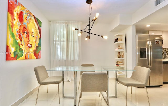 dining space featuring light tile patterned floors, visible vents, and baseboards