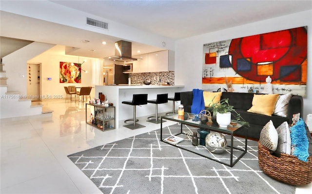 living room featuring visible vents and stairway