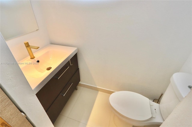 bathroom with toilet, tile patterned flooring, and vanity