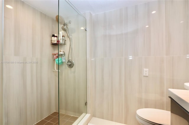 full bath featuring toilet, a shower stall, and vanity