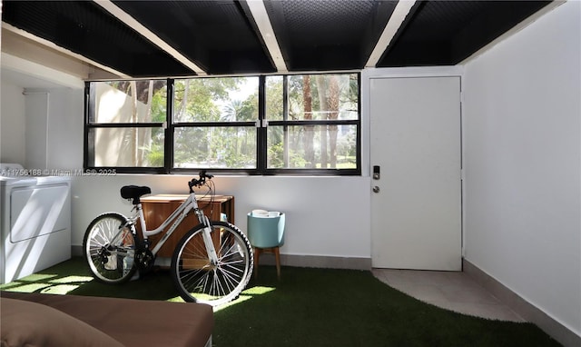 interior space featuring tile patterned flooring, washer / dryer, and baseboards