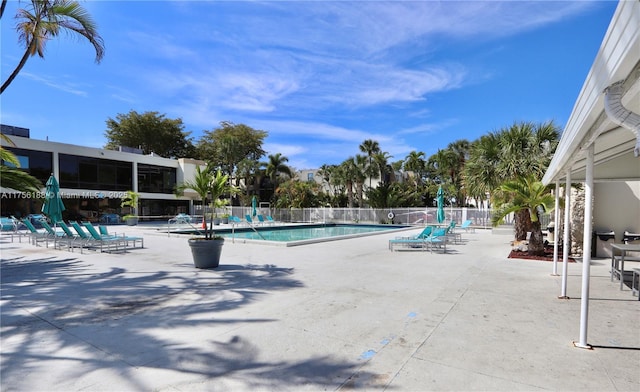 pool featuring fence and a patio