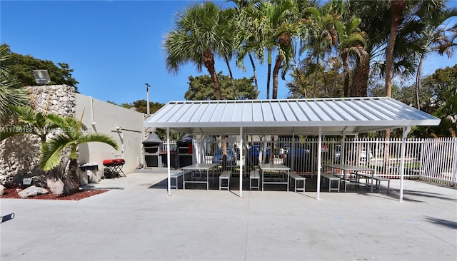 view of home's community featuring fence and a patio