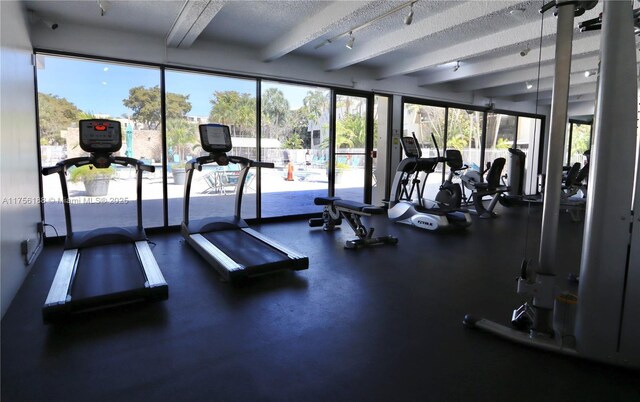 20350 W Country Club Dr Unit 104-4, Aventura, FL 33180 - workout area with beam ceiling, rail lighting, and a textured ceiling