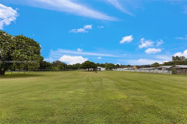 view of yard featuring fence and a rural view