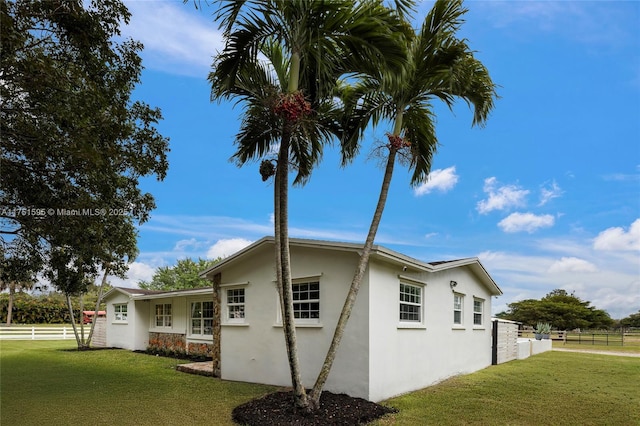 1970 SW 115th Ave, Davie, FL 33325 - view of side of home featuring stucco siding, a yard, and fence