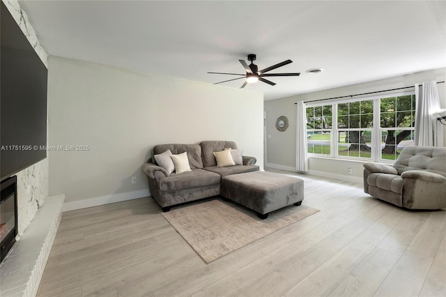 1970 SW 115th Ave, Davie, FL 33325 - living room featuring baseboards, ceiling fan, a fireplace, and light wood finished floors