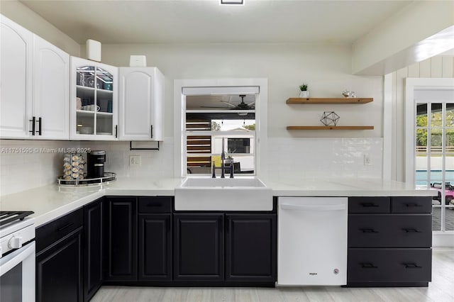 1970 SW 115th Ave, Davie, FL 33325 - kitchen with white cabinets, a sink, white appliances, dark cabinetry, and decorative backsplash