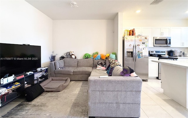 living area featuring light tile patterned floors and visible vents