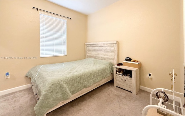 carpeted bedroom featuring baseboards