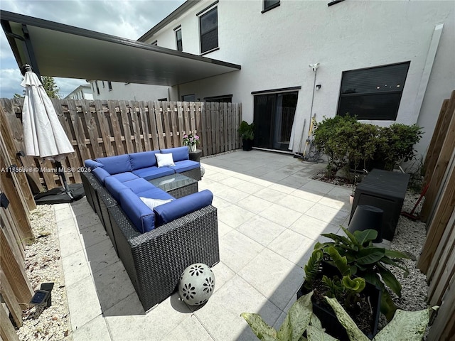 view of patio / terrace with fence and an outdoor living space