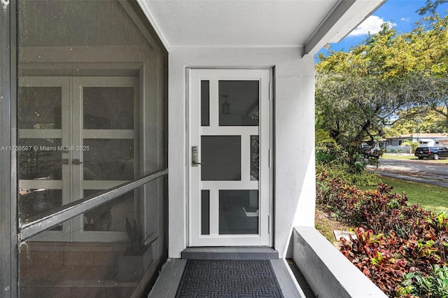 view of exterior entry with stucco siding