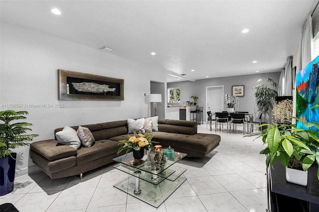 living area with recessed lighting and visible vents