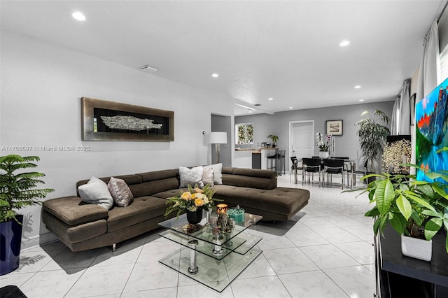 living area featuring recessed lighting and visible vents