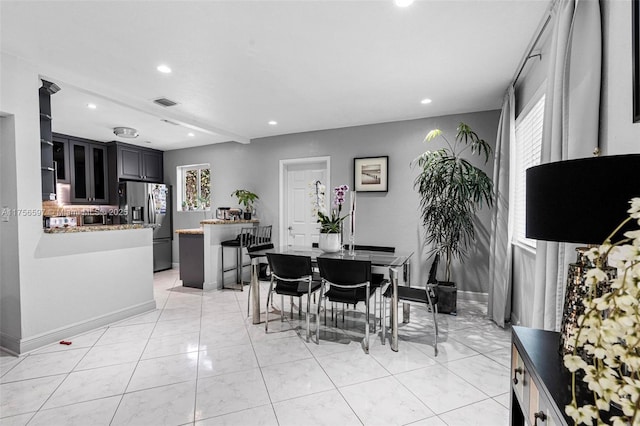 dining space with recessed lighting, light tile patterned floors, visible vents, and baseboards