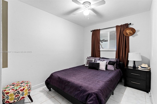 bedroom with baseboards, a ceiling fan, and marble finish floor
