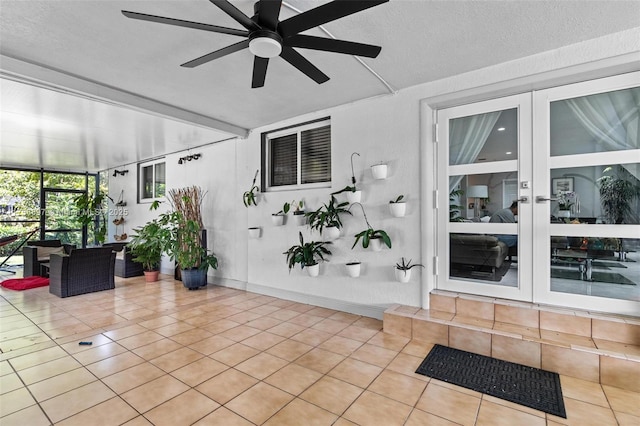 unfurnished sunroom with ceiling fan and beamed ceiling