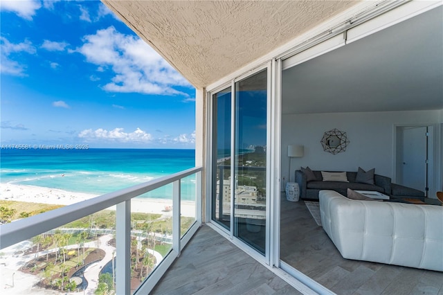 balcony with a water view and a beach view