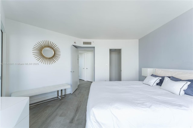 bedroom featuring light wood-style floors and visible vents