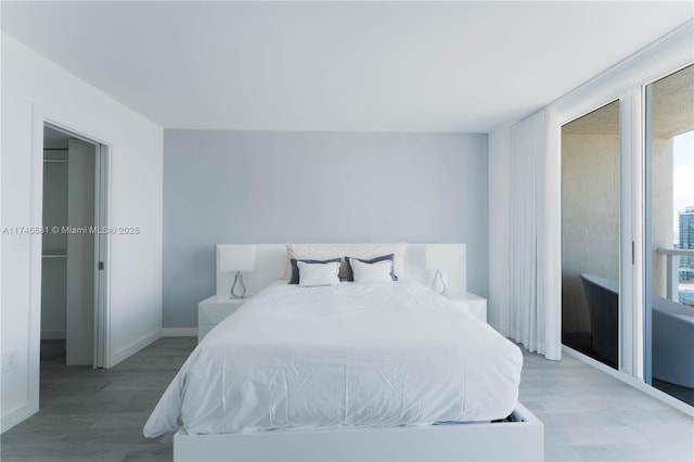 bedroom with baseboards and wood finished floors