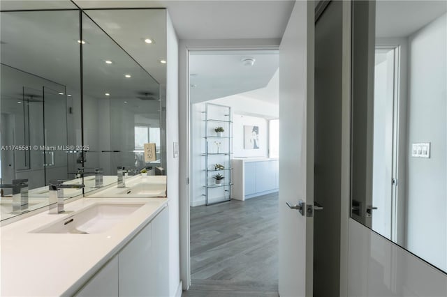 full bathroom with recessed lighting, wood finished floors, and vanity