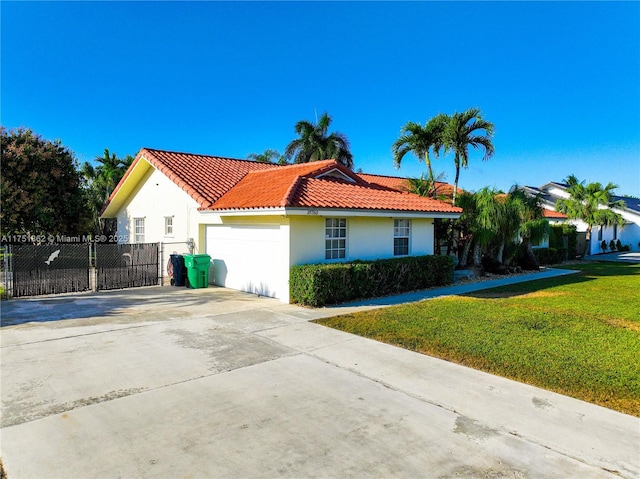 view of front of home featuring stucco siding, fence, driveway, a tiled roof, and a front lawn