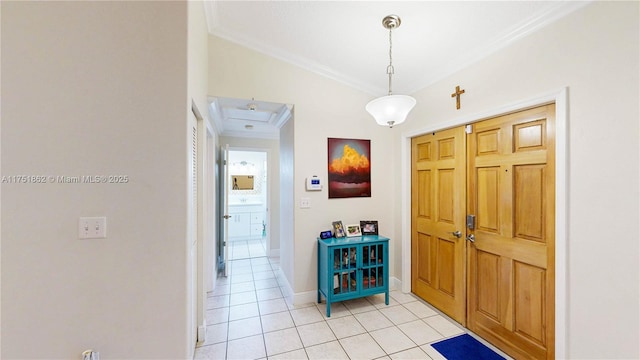 entrance foyer with light tile patterned floors, ornamental molding, and baseboards