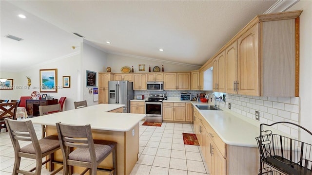 kitchen with stainless steel appliances, visible vents, light brown cabinets, a sink, and light tile patterned flooring