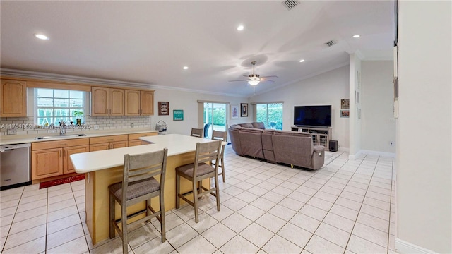 kitchen featuring light countertops, visible vents, stainless steel dishwasher, light tile patterned flooring, and a sink