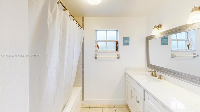 bathroom featuring shower / bath combination with curtain, tile patterned flooring, vanity, and baseboards