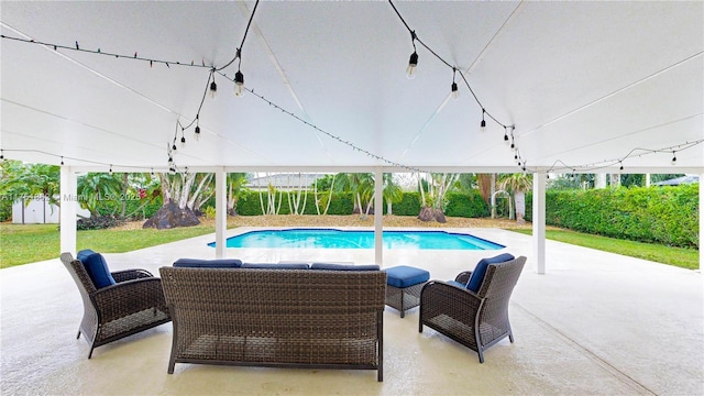 view of swimming pool with outdoor lounge area, a fenced in pool, and a patio